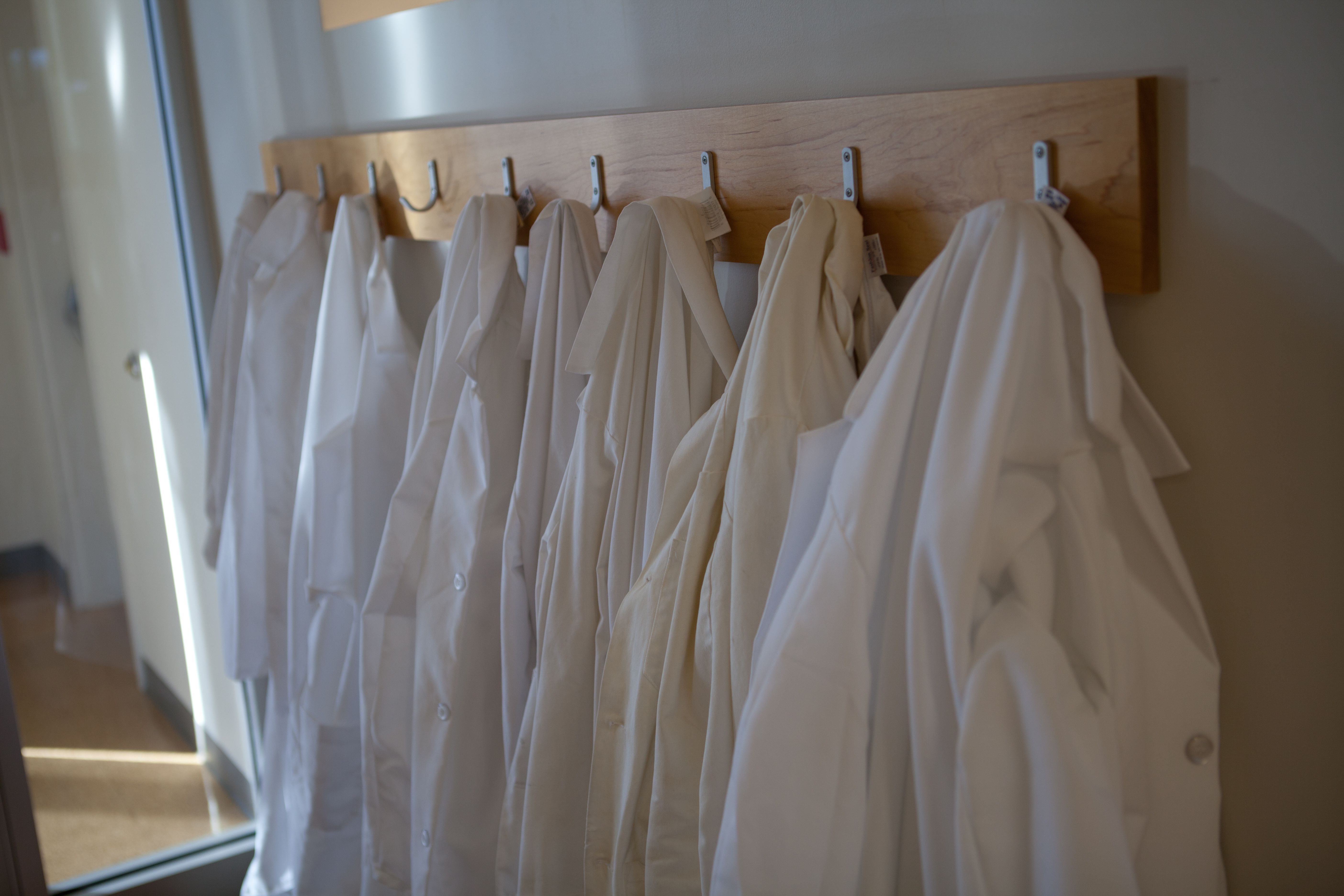 Hanging white lab coats