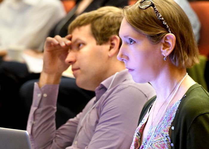 Two audience members listening at the Rewriting Genomes Symposium