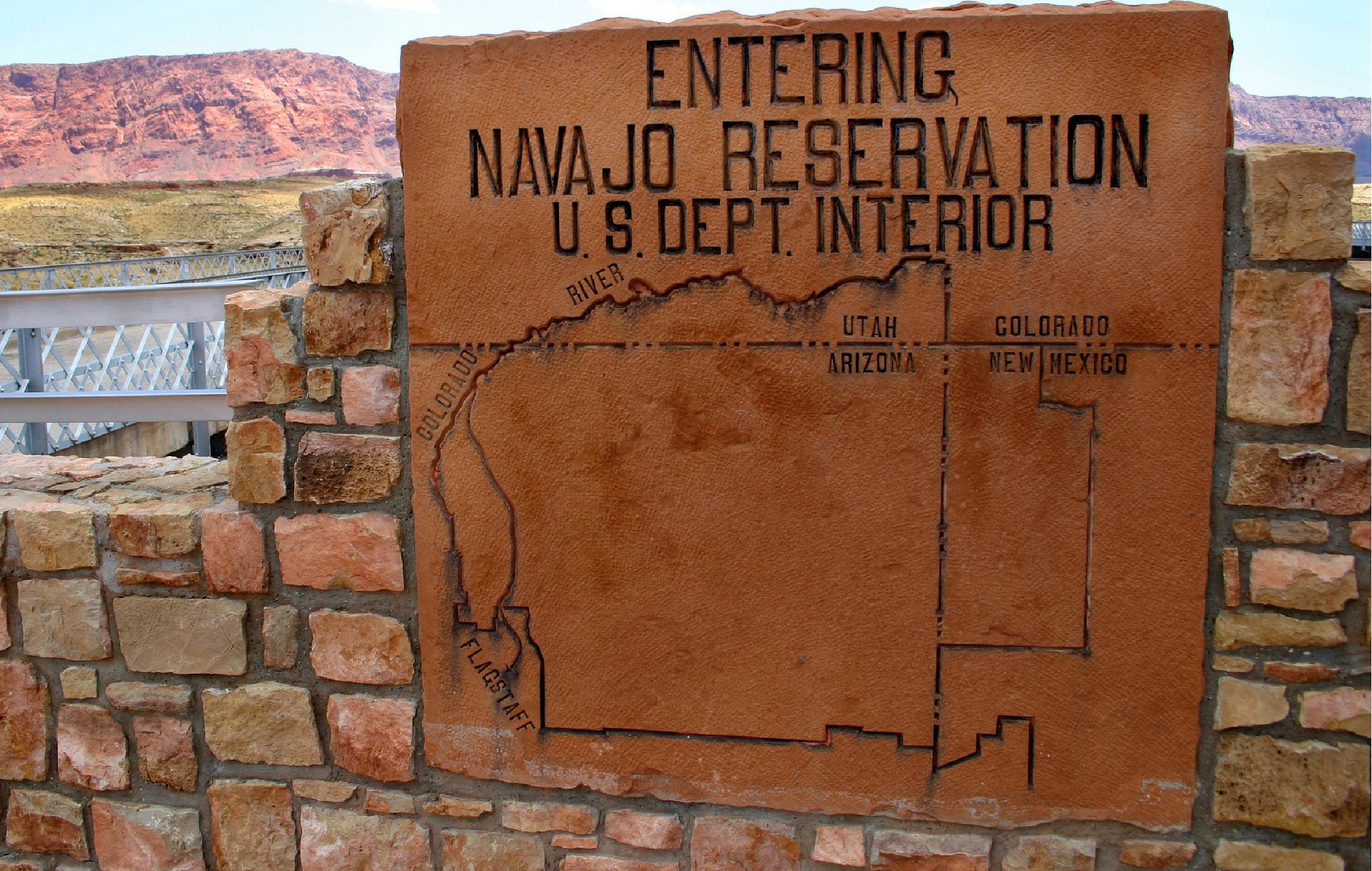 Sign at the entrance of the Navajo Nation with a map of the reservation location