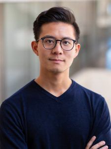 Patrick Hsu, an Asian male in a sweater and glasses