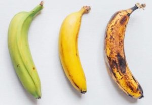 green, yellow, and brown bananas compared