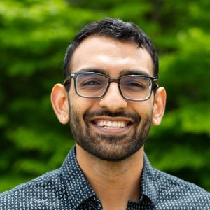 Dhruv Patel-Tupper, smiling in glasses