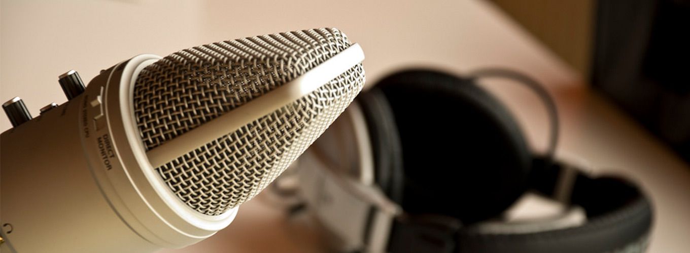 A microphone and headphones set up to record a podcast