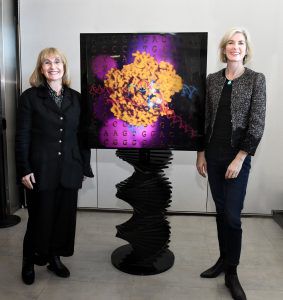 Ellen Sandor and Jennifer Doudna standing in front of a Cas9 art installation