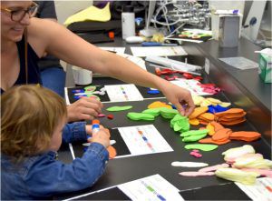 Child playing arts and crafts with a parent