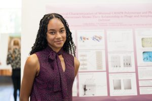 Cydni Bolling stands in front of her poster