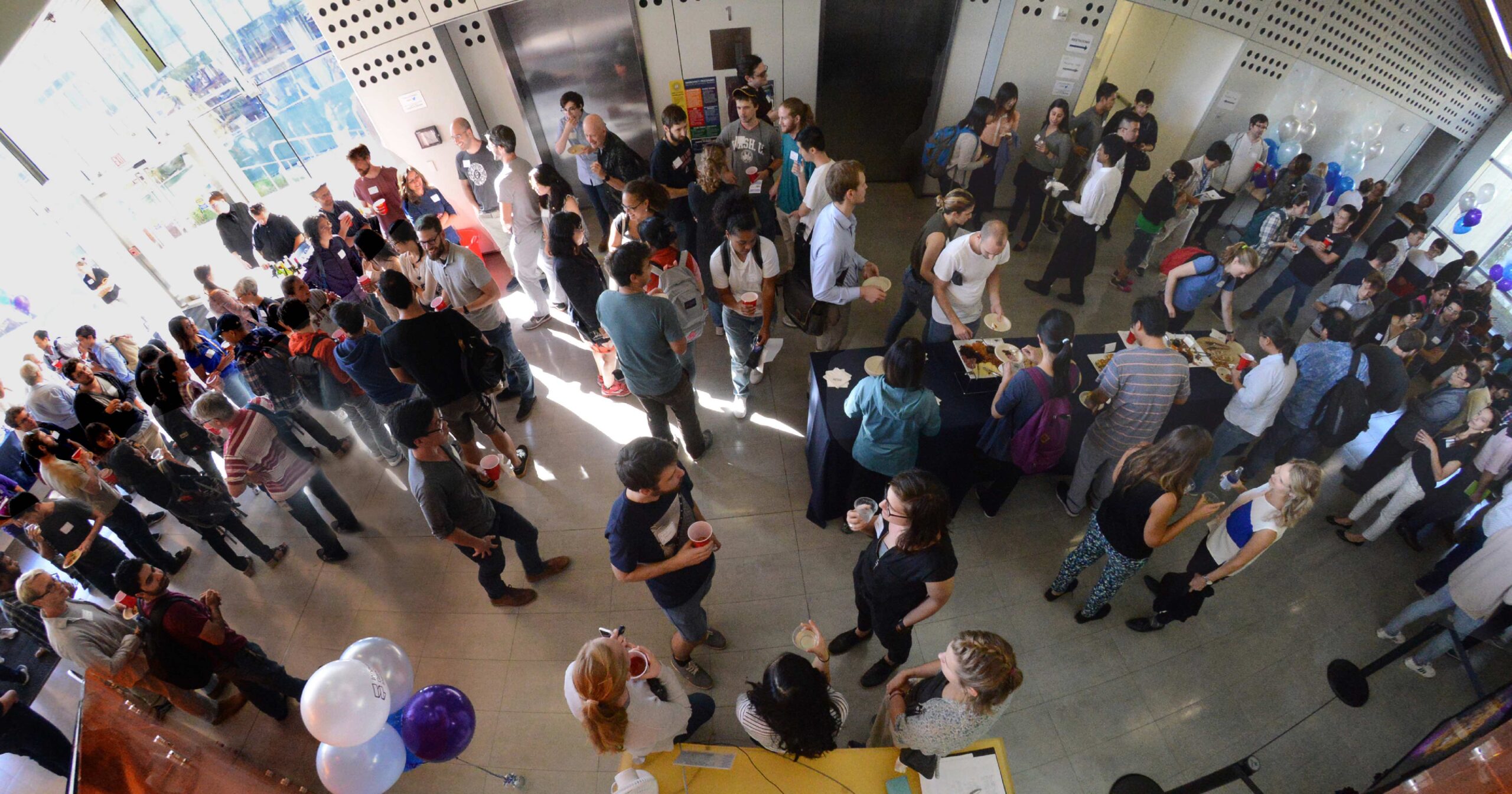 Many people in the lobby of the Energy Biosciences Building for the IGI Open House