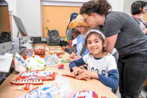 Child building DNA out of twizzlers and marshmellows