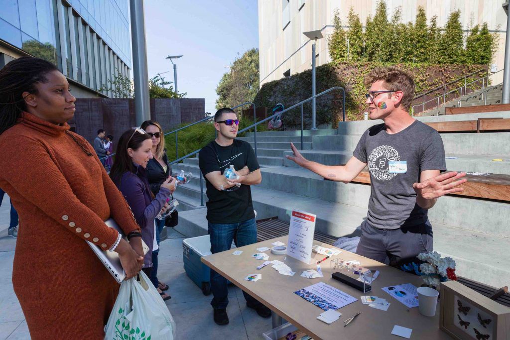 photo of Tyler Ford talking to visitors