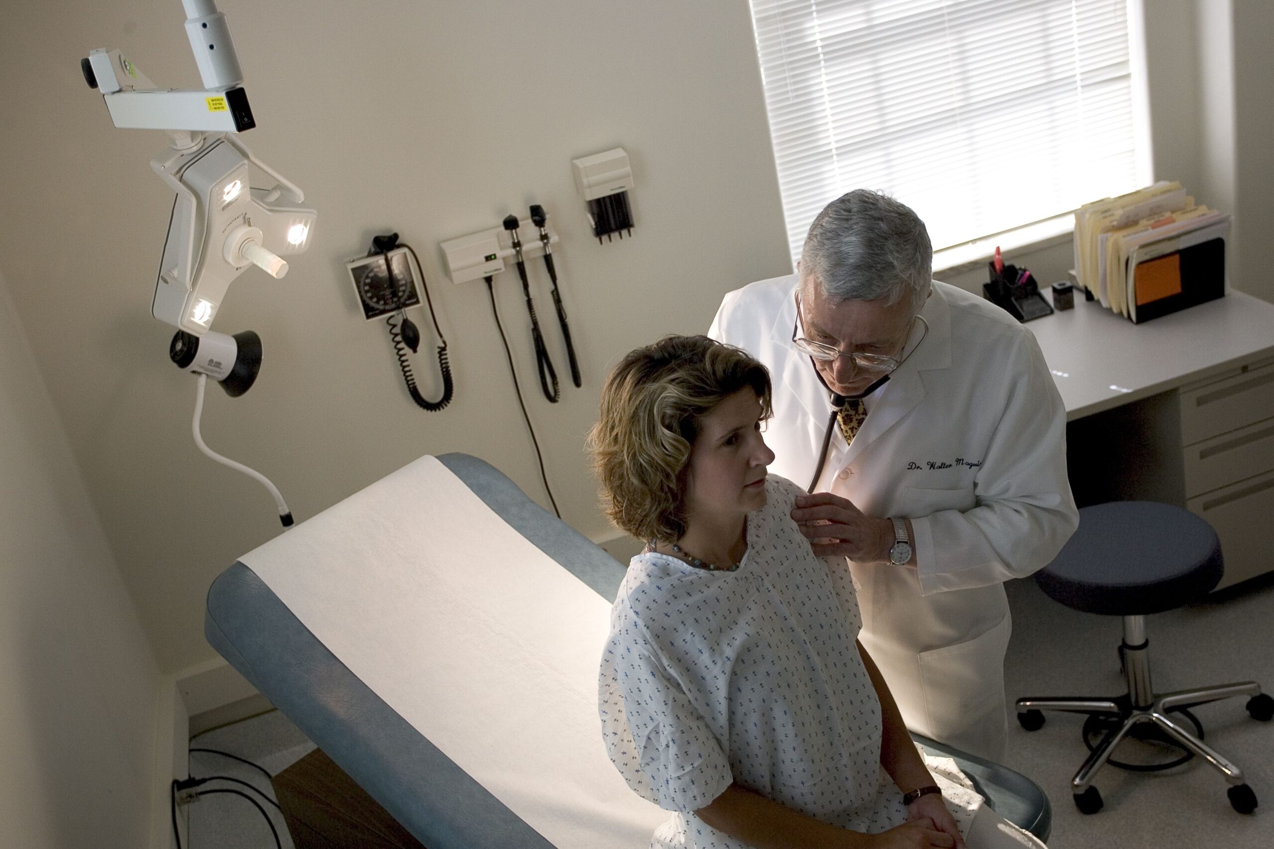 Doctor using a stethoscope on a patient in a doctor's office