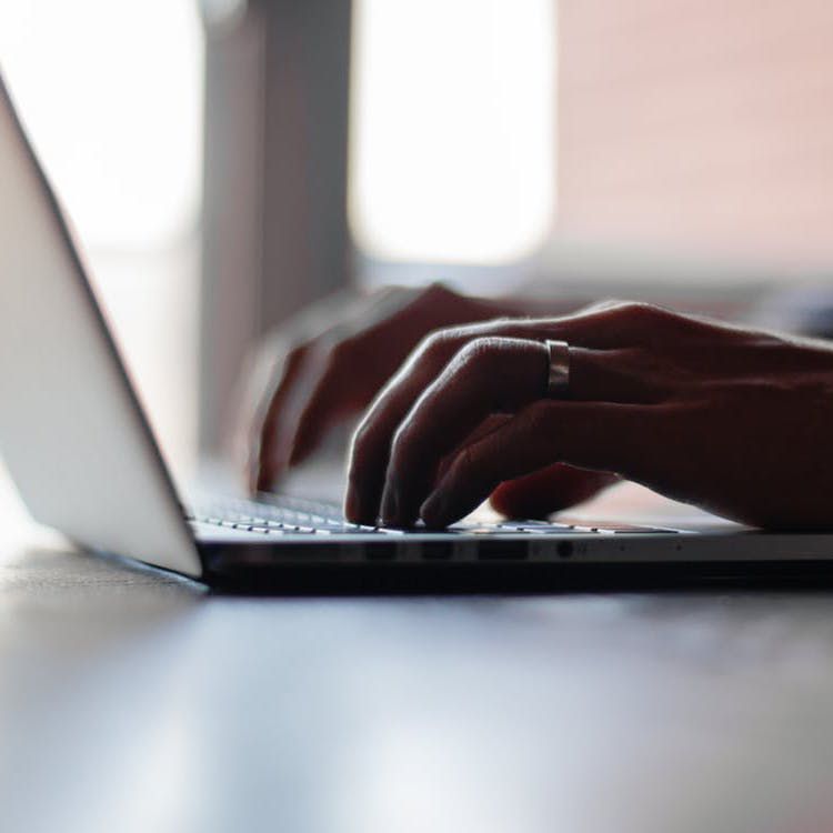 Hands typing on keyboard