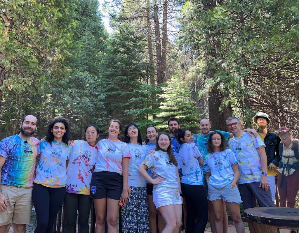 lab members in a forest wearing tie-dye