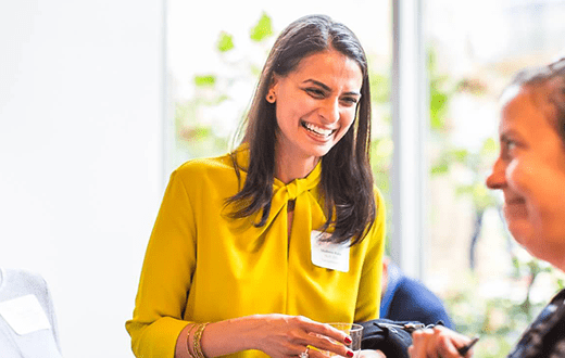 Shaheen Kabir laughing in a yellow shirt