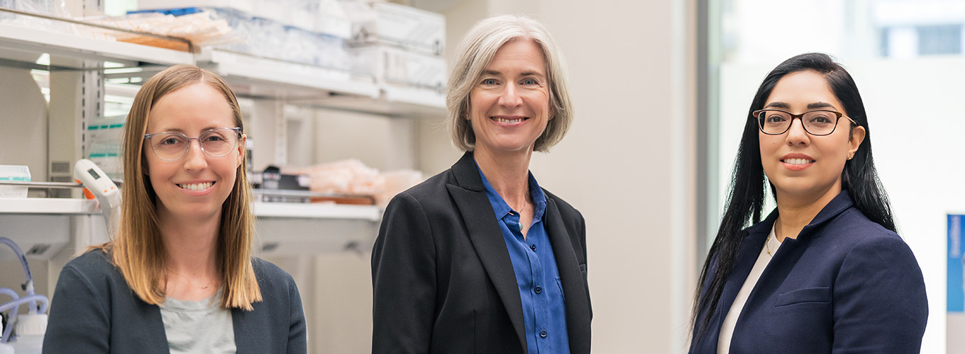 Jennifer Doudna smiling with Jenny Hamilton and Navneet Matharu