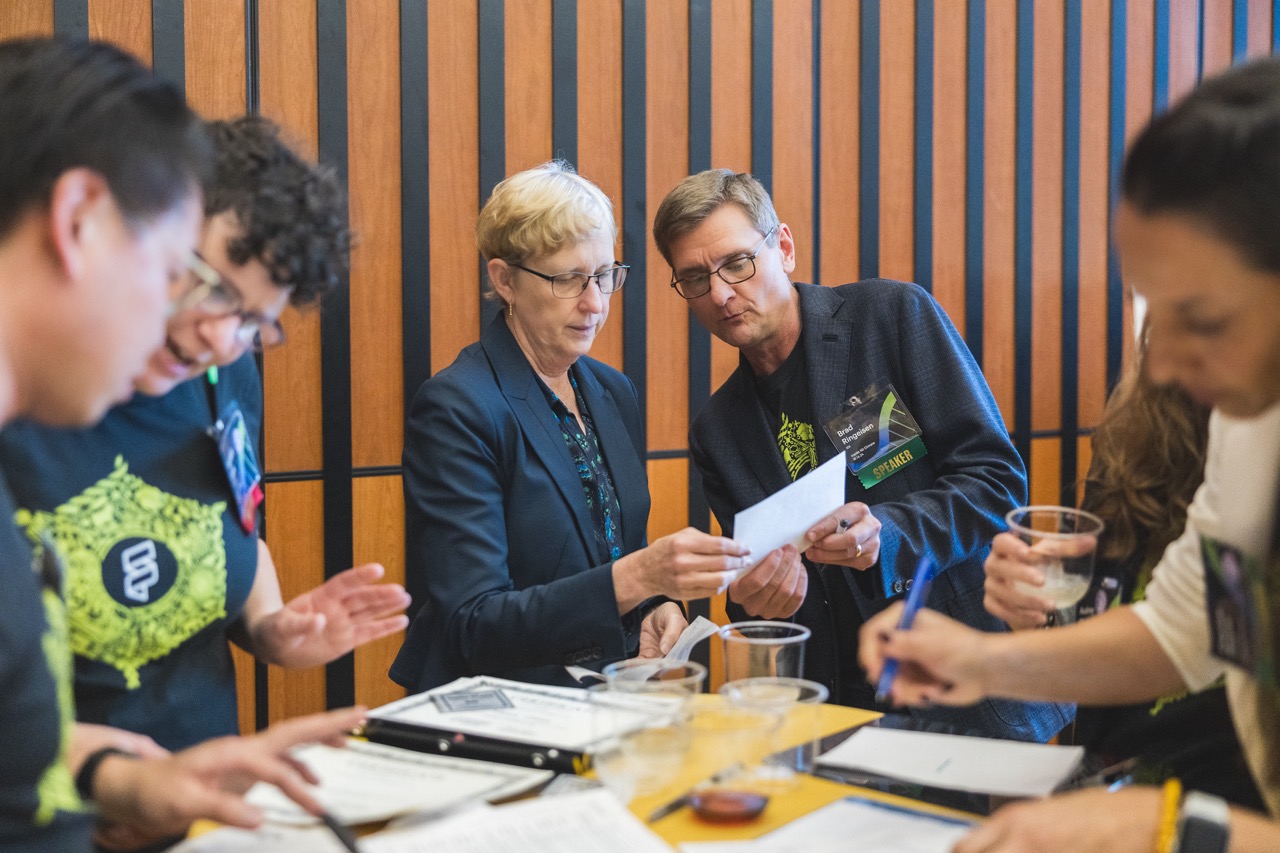 Vice Chancellor for Research Kathy Yellick consults with Brad Ringeisen about the winners of the 2024 poster session.